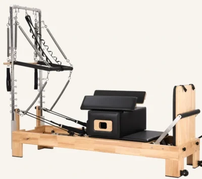 Vimora oak wood Pilates reformer with built-in footbar with half tower, for professional studio use