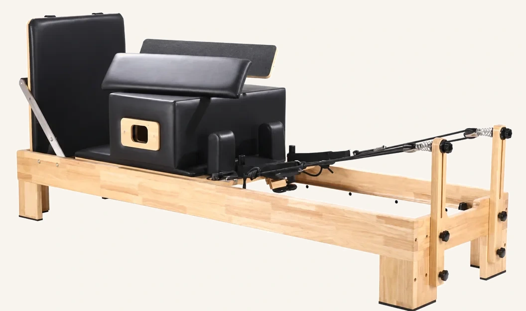 vimora reformer oak built in footbar.webp Vimora oak wood Pilates reformer with built-in footbar, for professional studio use