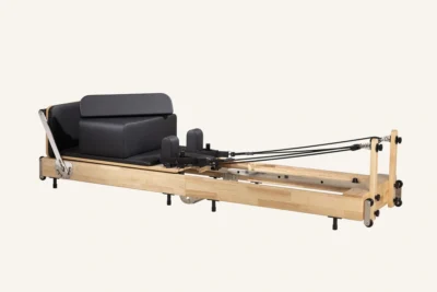 Vimora oak wood folding Pilates reformer with steel legs, for professional studio use